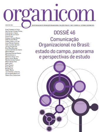 Capa da revista com fundo branco, título em letras grandes e roxas no topo com detalhes da edição em uma linha logo abaixo. À esquerda, há uma lista vertical de nomes. No centro, um título em roxo com o tema da edição. Abaixo do tema há um desenho abstrato feito de círculos de vários tamanhos e tons de roxo diferentes interligados por linhas.