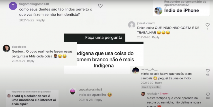 Trecho do documentário Comunidade Indígena e o Ciberespaço. Print de vários comentários de diferentes usuários em redes sociais. No centro da imagem, em destaque, encontra-se a caixa de perguntas do Instagram onde se lê: “Indígena que usa coisa do homem branco não é mais indígena”. Os comentários mostrados veiculam ideias preconceituosas em relação aos povos indígenas, que os classificam como preguiçosos e atrasados. 