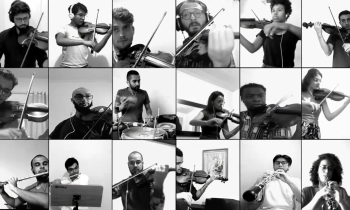Captura de tela de um dos vídeos da Orquestra da Câmara da ECA. A imagem em preto e branco está dividida entre várias pessoas, homens e mulheres, todas tocando diferentes instrumentos.
