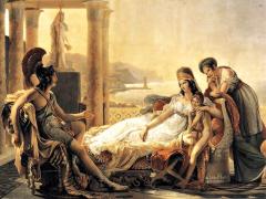 ​ Pintura clássica. De um lado, Enéas, um homem branco em uma armadura e capacete, está sentado em uma cadeira, gesticulando em conversa. Ao seu lado, Dido, uma mulher branca de cabelos longos e castanhos, está reclinada em um divã. Ela usa um vestido longo e branco e um adorno na cabeça. Ela está abraçada a uma criança, de pé, ao seu lado. Uma outra mulher, usando um vestido longo azul, está de pé, apoiada no encosto do divã. A cena se passa em um terraço com colunas. Ao fundo, há montanhas e a praia